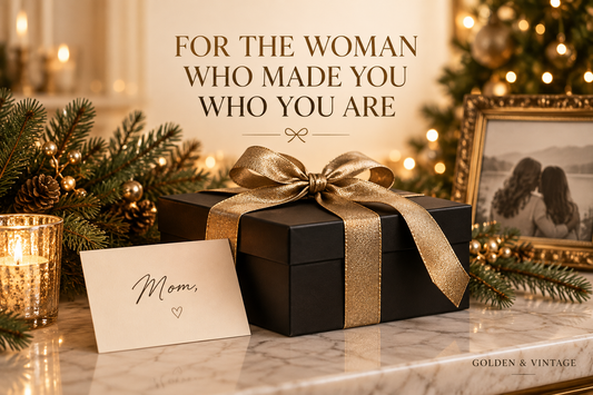 Black Christmas gift box with gold ribbon, a card for Mom and a framed mother-daughter photograph