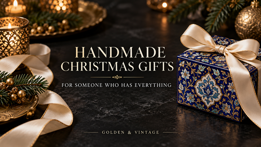 Handmade Christmas gift wrapped in ivory ribbon beside Persian-inspired blue floral patterns in Golden & Vintage black and gold styling