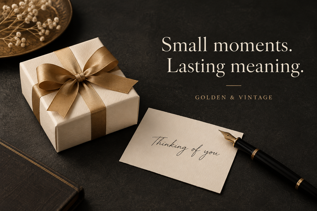 Ivory gift box tied with gold ribbon beside a Thinking of you note on a charcoal surface, with Golden & Vintage branding.